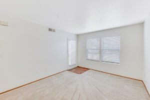 Interior Unit Living Room, neutral toned carpeting, white walls.